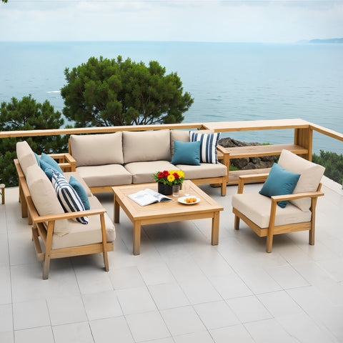 Deep seat and back cushion set displayed on an outdoor sofa and chairs at a seaside house by Crestlive Products