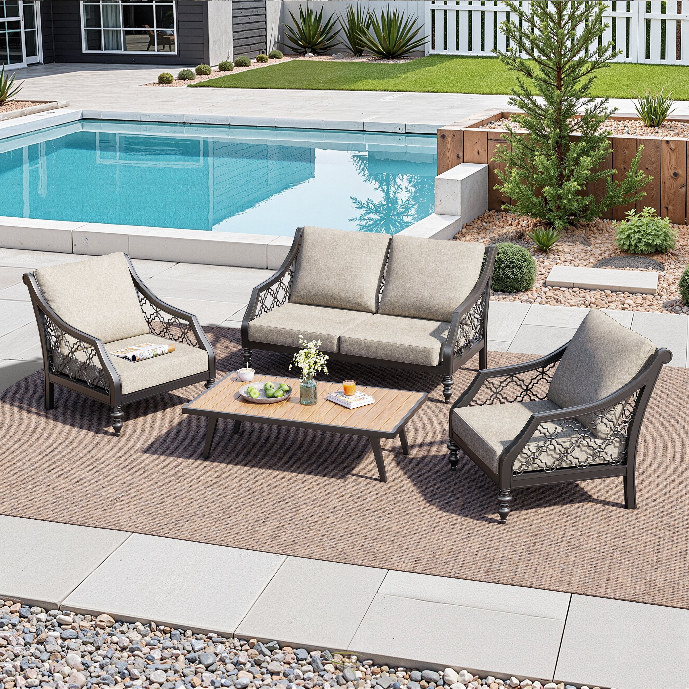Outdoor deep seat cushions arranged on sofa-style seating and stools by the pool, styled with a small accent table