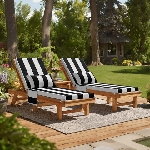 Two wooden outdoor chaise lounges with black-and-white striped cushions on a garden deck