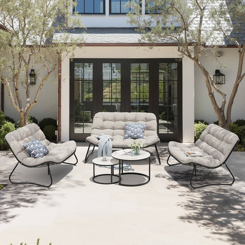 Steel outdoor loveseat and chairs set with side tables in a backyard setting