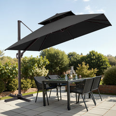 Tilted 10x10 ft square black cantilever patio umbrella with steel cross base shading a patio dining set