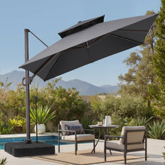 Tilted 10x10 ft square grey cantilever patio umbrella with wheeled base shading a poolside dining set