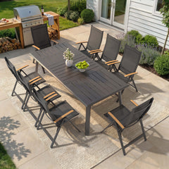 9-piece patio dining set with aluminum expandable table and 8 folding textilene chairs on patio.