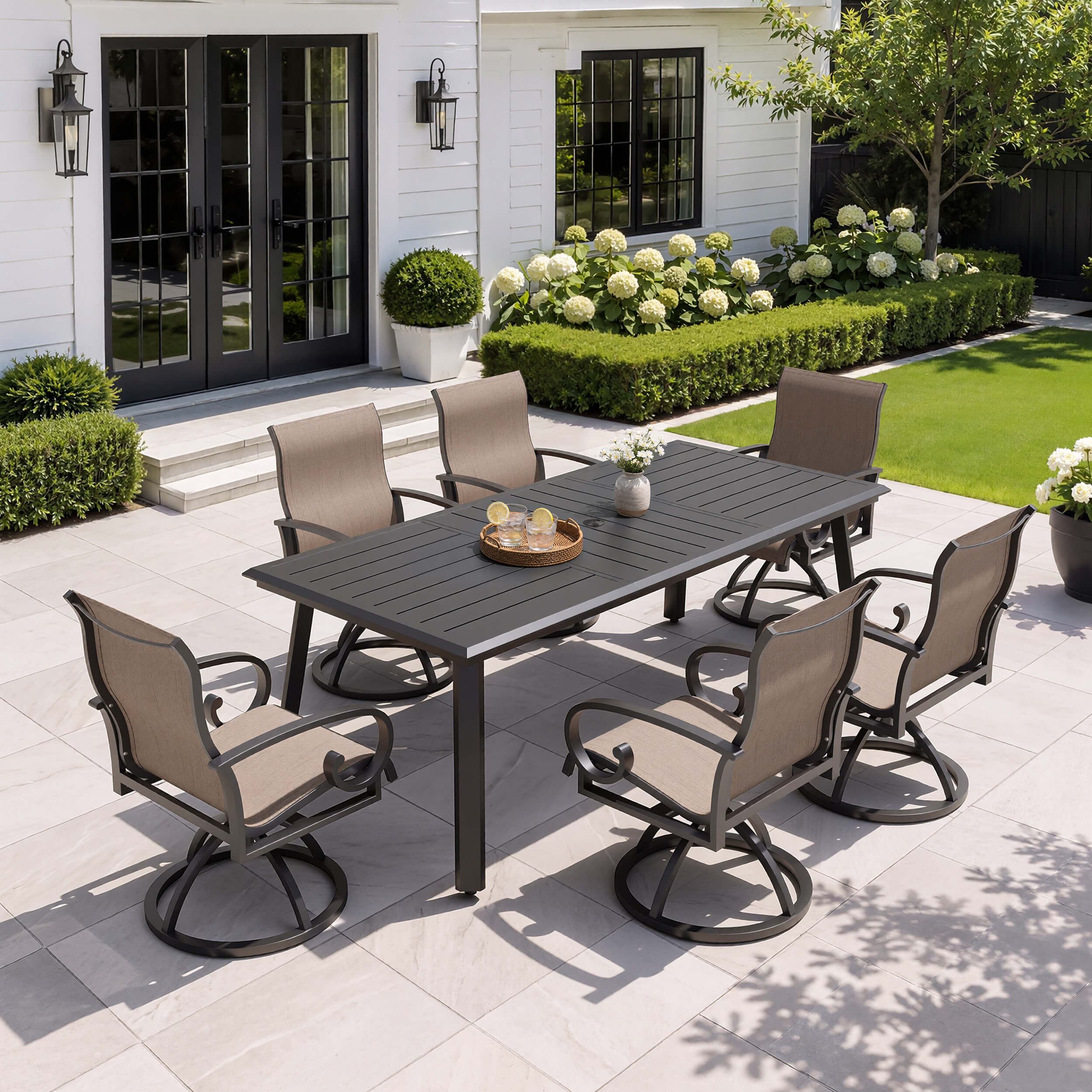 7-piece patio dining set with aluminum expandable table and 6 swivel Sunbrella chairs on patio.