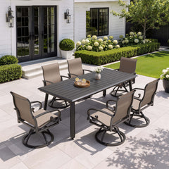 7-piece patio dining set with aluminum expandable table and 6 swivel Sunbrella chairs on patio.