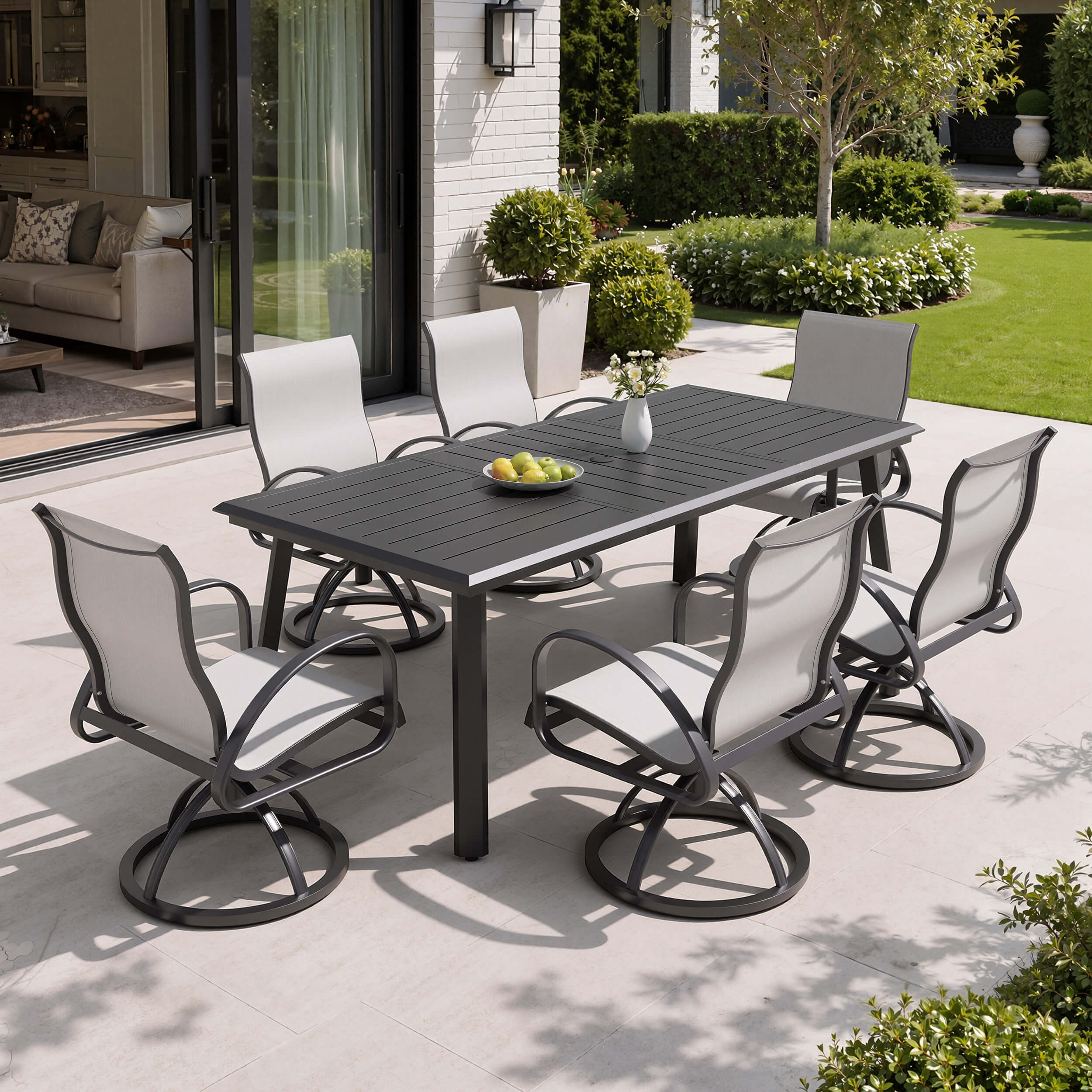 7-piece patio dining set with aluminum expandable table and 6 Sunbrella swivel rockers on patio.