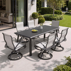 7-piece patio dining set with aluminum expandable table and 6 Sunbrella swivel rockers on patio.