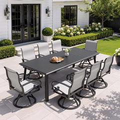 9-piece patio dining set with aluminum expandable table and 8 grey swivel Sunbrella chairs on patio.