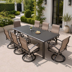 9-piece patio dining set with aluminum expandable table and 8 Sunbrella swivel rockers on patio.