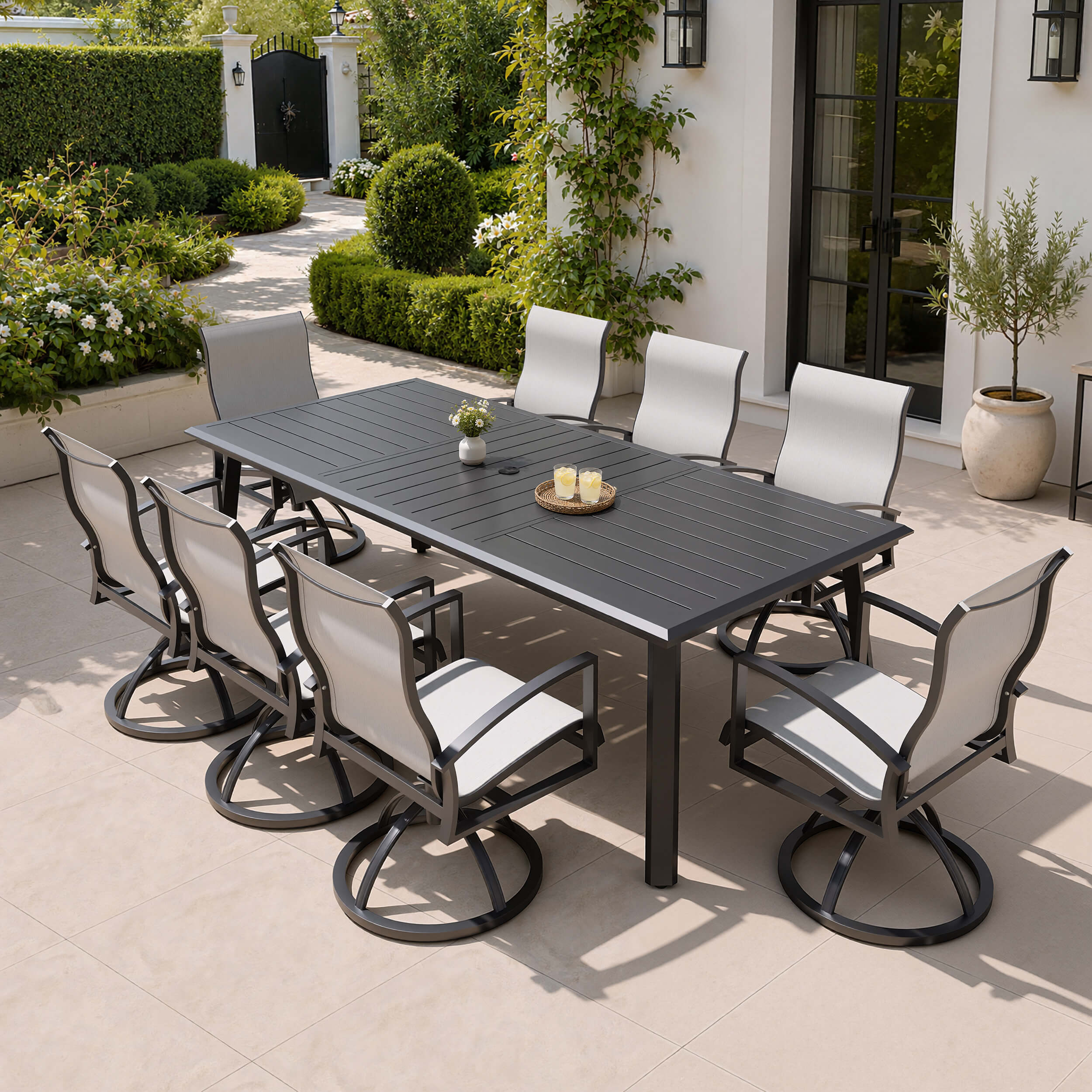 9-piece patio dining set with aluminum expandable table and 8 Sunbrella swivel rockers on patio.