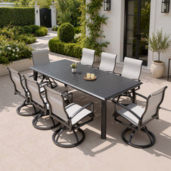 9-piece patio dining set with aluminum expandable table and 8 Sunbrella swivel rockers on patio.