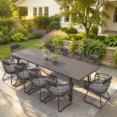 11-piece patio dining set with aluminum expandable table and 10 grey wicker chairs on patio.