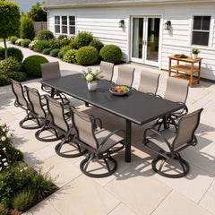 11-piece patio dining set with aluminum expandable table and 10 Sunbrella swivel rockers on patio.