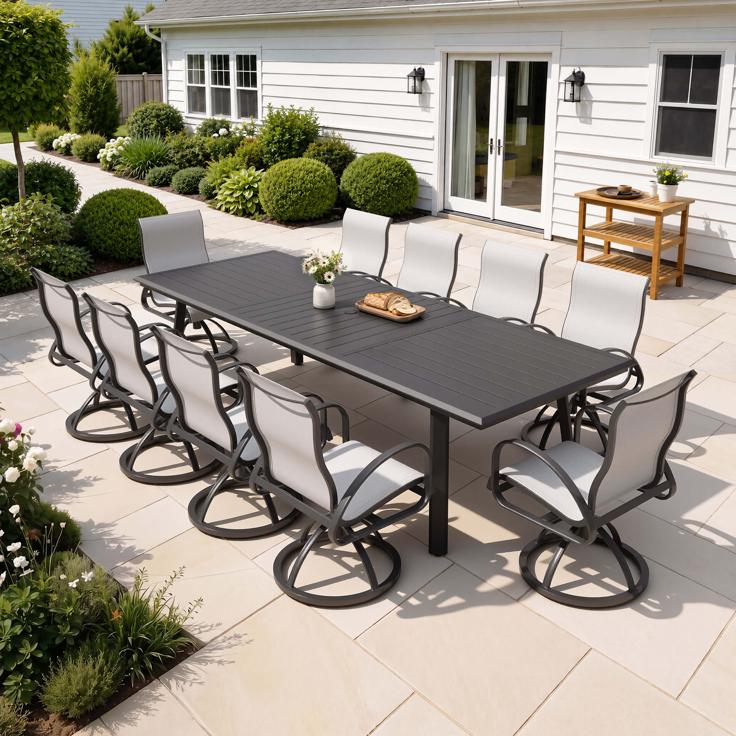 11-piece patio dining set with aluminum expandable table and 10 Sunbrella swivel rockers on patio.