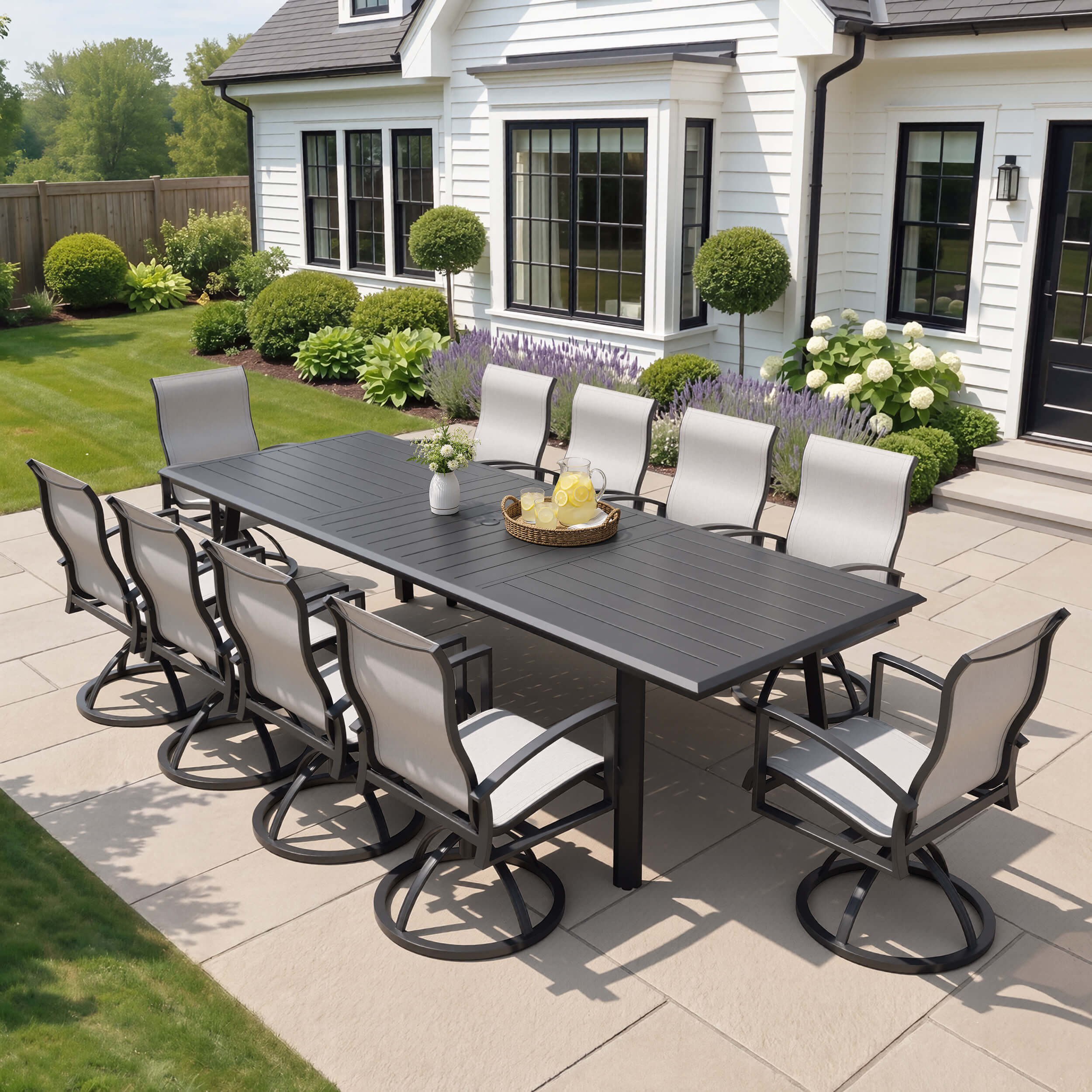 11-piece patio dining set with aluminum expandable table and 10 Sunbrella swivel rockers on patio.