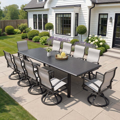 11-piece patio dining set with aluminum expandable table and 10 Sunbrella swivel rockers on patio.