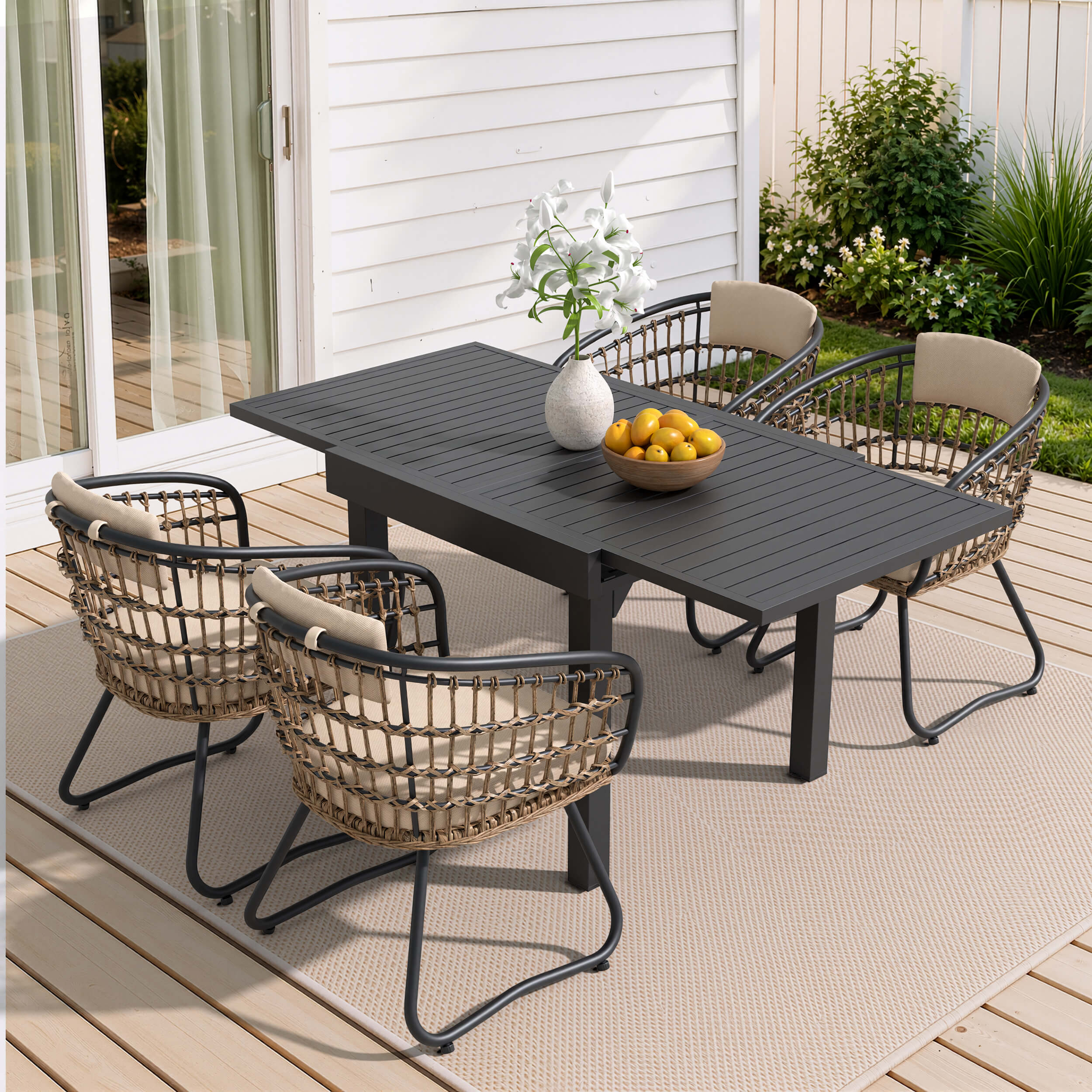 5-piece expandable patio dining set with black aluminum table and 4 PE rattan chairs on deck.