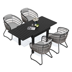5-piece expandable patio dining set with black aluminum table and 4 PE rattan chairs with grey cushions.