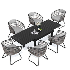 7-piece expandable patio dining set with black aluminum table and 6 grey PE rattan chairs.
