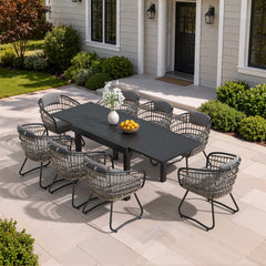 9-piece expandable patio dining set with black aluminum table and 8 grey PE rattan chairs on patio.